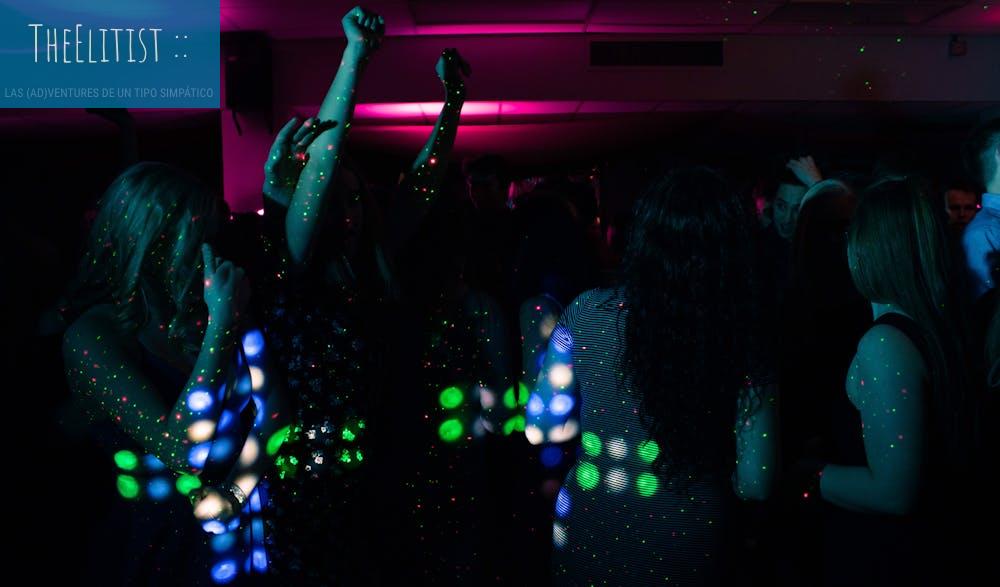 Energetic nightclub scene with people dancing under colorful neon lights. Perfect for nightlife themes.