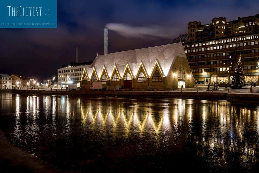 Illuminated fish market hall with reflections in Gothenburg at night.