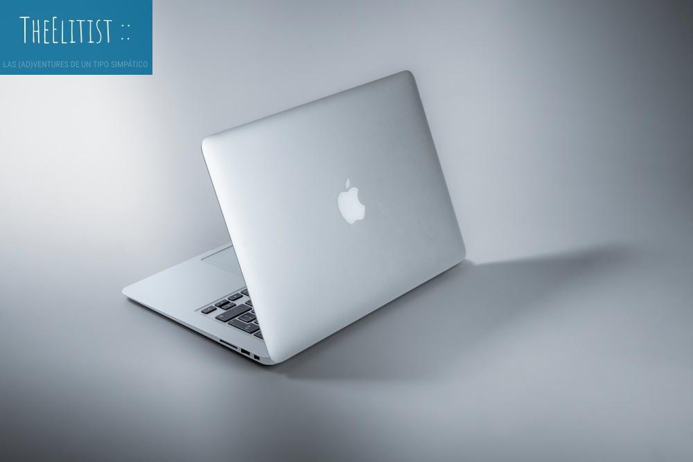 silver macbook on white table